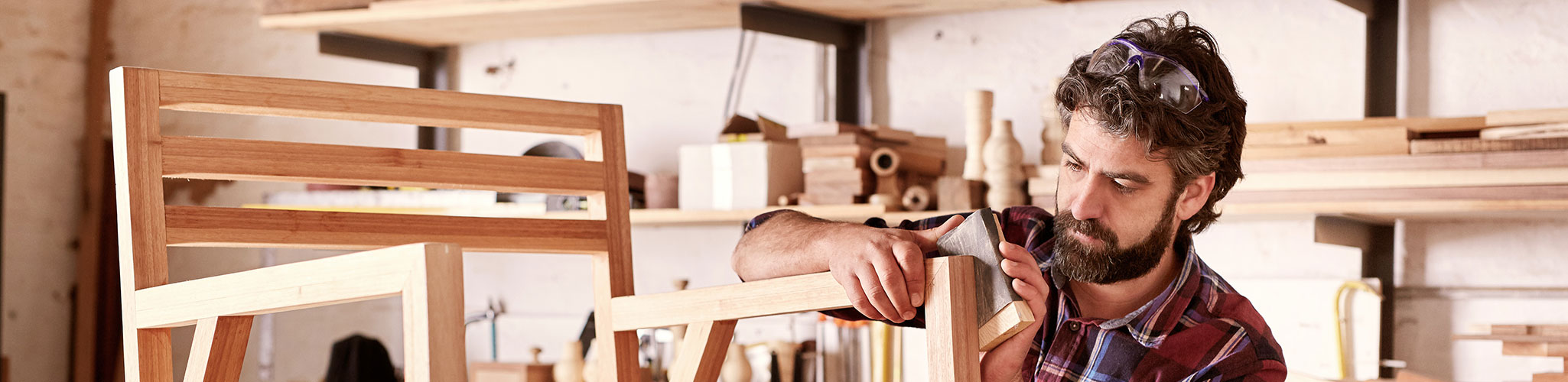 Bearded man building a chair in a workshop
