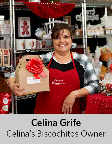 Photo of Celina Grife, owner of Celina's Biscochitos, grinning and holding gift-wrapped box of biscochitos